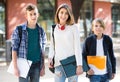 Teens going to school with papers