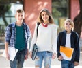 Teens going to school with papers Royalty Free Stock Photo