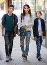 Teens going to school with papers Royalty Free Stock Photo