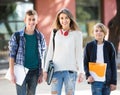 Teens going to school with papers Royalty Free Stock Photo