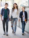 Teens going to school with papers Royalty Free Stock Photo