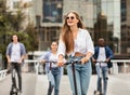 Teens having ride on electric kick scooters Royalty Free Stock Photo