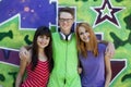 Teens with headphones near graffiti wall. Royalty Free Stock Photo