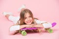 Teens hobby concept. Girl likes to ride skateboard and sporty lifestyle. Girl on smiling face posing with penny board Royalty Free Stock Photo