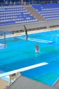 Teens jumping into outdoor pool Royalty Free Stock Photo