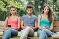 Teens at the park using smart phones