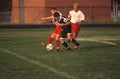 Teens playing a high school soccer game