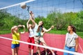 Teens are playing volleyball together on the court Royalty Free Stock Photo