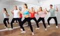 Teens practicing dance with female trainer