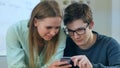 Teens reading some content in smartphone that makes them smile