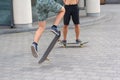 Teens ride a skateboard in the city