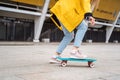 Teens ride a skateboard in the city. Youth culture