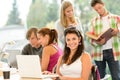 Teens studying in high-school library young pupils