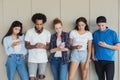 Teens using cellphones, disinterested to each other
