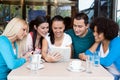 Teens using their digital tablet in a cafe Royalty Free Stock Photo