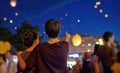 Teens watching paper flying lanterns