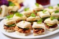 teeny bbq sandwiches for a party, white plates