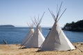 Teepee Camp By Water Royalty Free Stock Photo