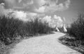 Teepee's sitting at the end of a winding gravel pathway.