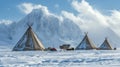 Teepees in a snowy landscape with mountains in the background