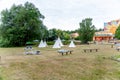 Teepees and Sun Loungers in a Park Landscape