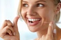 Teeth Care. Beautiful Smiling Woman Flossing Healthy White Teeth Royalty Free Stock Photo