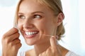 Teeth Care. Beautiful Smiling Woman Flossing Healthy White Teeth Royalty Free Stock Photo