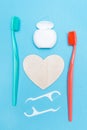 Teeth hygiene and oral dental care products. Morning concept. Dental floss, toothbrush and heart. Vertical. Blue Royalty Free Stock Photo