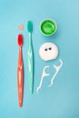 Teeth hygiene and oral dental care products. Morning concept. Dental floss. Vertical. Blue background. Oral Care Set. Royalty Free Stock Photo