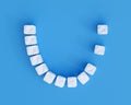 Teeth made of sugar cubes on blue background, two teeth missing. Sweet tooth dental health care concept Royalty Free Stock Photo