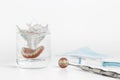 Teeth on mirror next to dentures in water