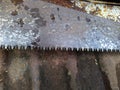 teeth of an old saw on a dirty and pink metal background Royalty Free Stock Photo