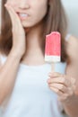 Teeth Sensitive to Cold concept. woman hold Ice cream and having toothache and pain after eat. Tooth Decay or Gum Disease, Royalty Free Stock Photo