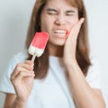 Teeth Sensitive to Cold concept. woman hold Ice cream and having toothache and pain after eat. Tooth Decay or Gum Disease, Royalty Free Stock Photo