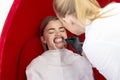 Teeth whitening procedure girl reception dentist for teeth whitening the doctor applies the drug to the patient teeth