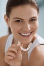 Teeth whitening. Woman with healthy teeth using removable braces Royalty Free Stock Photo