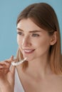 Teeth whitening. Woman with healthy teeth using removable braces