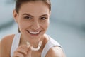 Teeth whitening. Woman with healthy teeth using removable braces