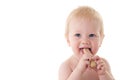 Teething baby chewing on rusk