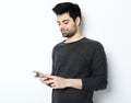 tehnology, emotion and people concept: Smiling young man talking by smartphone