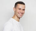 Tehnology, people and lifestyle concept: young man wearing white t-shirt using a tablet computer Royalty Free Stock Photo