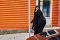 Iranian woman walks down the street, Tehran, Iran.