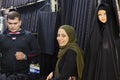 Smiling girl is selling black cloth, Tehran, Iran.