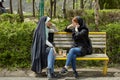 Two Iranian women are talking on the bench, Tehran.