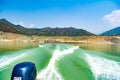 Tehri Lake, water surface behind of fast moving motor boat in Tehri lake. Trail on water surface behind speed boat. Rear view of Royalty Free Stock Photo