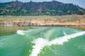 Tehri Lake, water surface behind of fast moving motor boat in Tehri lake. Trail on water surface behind speed boat. Rear view of Royalty Free Stock Photo