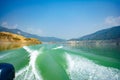 Tehri Lake, water surface behind of fast moving motor boat in Tehri lake. Trail on water surface behind speed boat. Rear view of Royalty Free Stock Photo