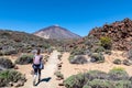 Teide - Woman on hiking trail La Fortaleza from El Portillo. Panoramic view on volcano Pico del Teide Royalty Free Stock Photo