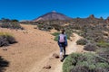 Teide - Woman on hiking trail La Fortaleza from El Portillo. Panoramic view on volcano Pico del Teide