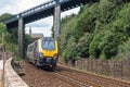 A train passing under the footbridge having just left Teignmouth station in Devon UK Royalty Free Stock Photo